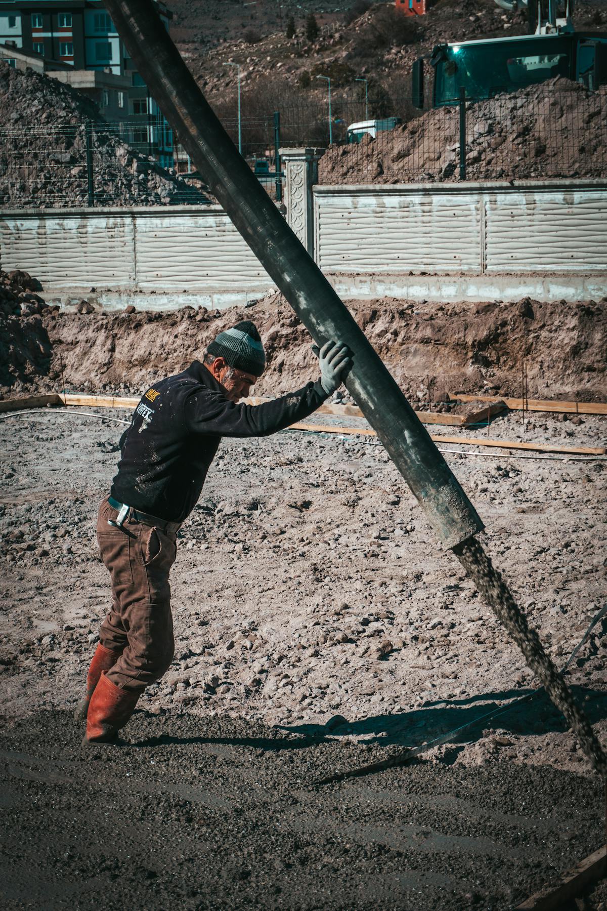 Marco on site, working the line pump hose during a residential pour